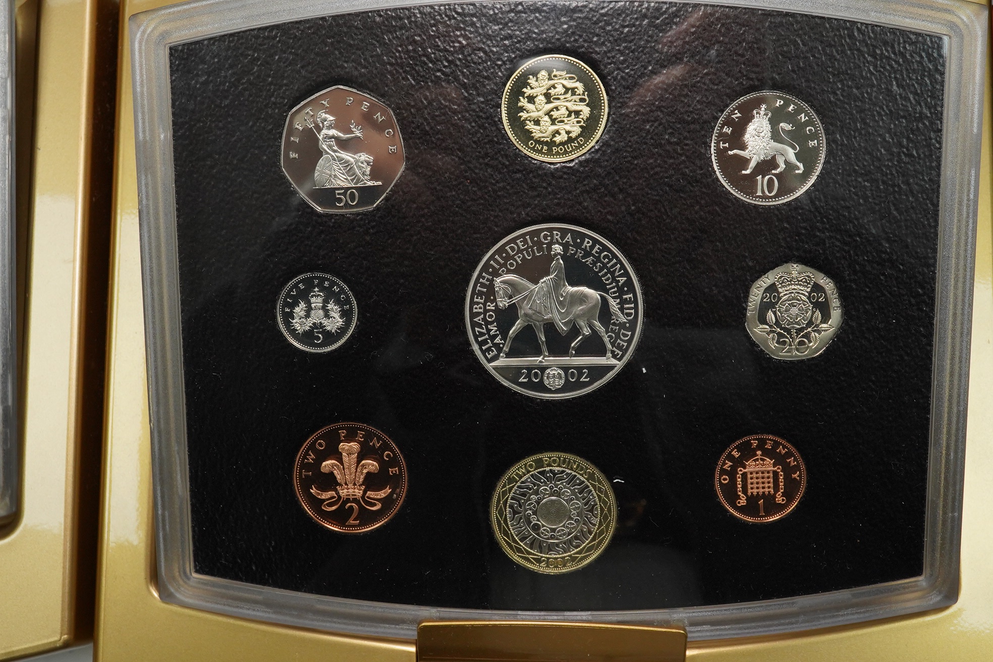 Royal Mint UK QEII coins, four executive proof coin sets, 2002 & 2003 in Golden Jubilee cases with certificates, 2007 & 2008, in wood cases of issue with certificates